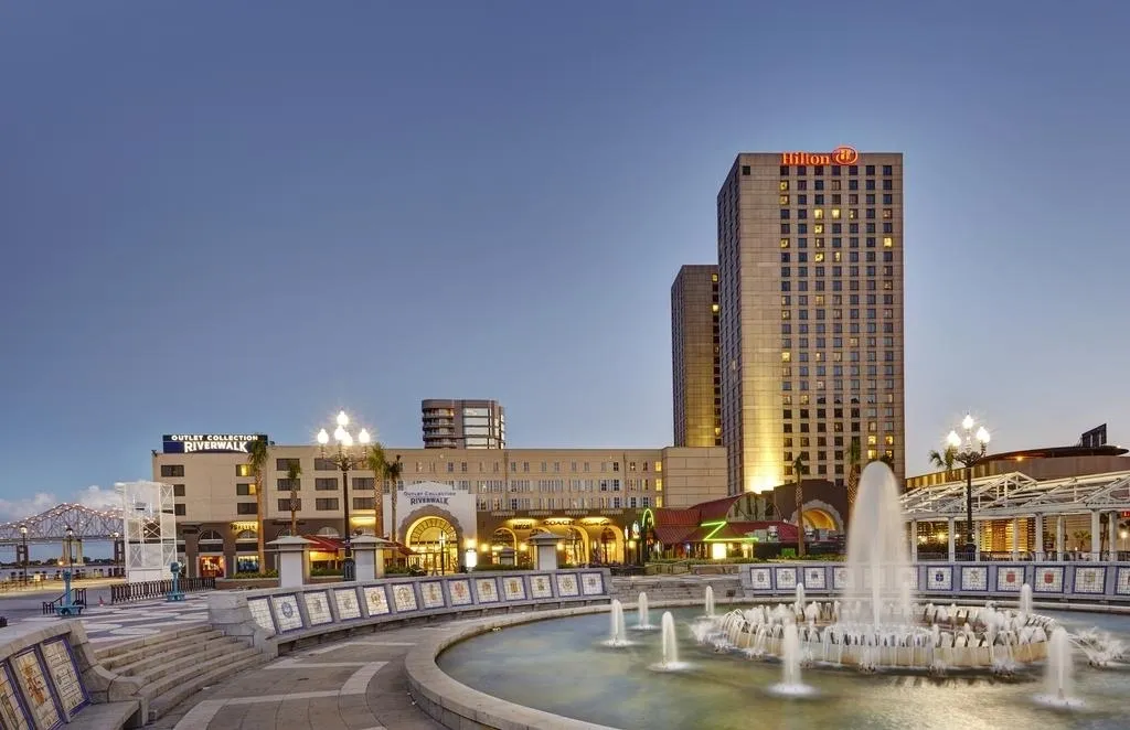 Hilton New Orleans Riverside building during evening